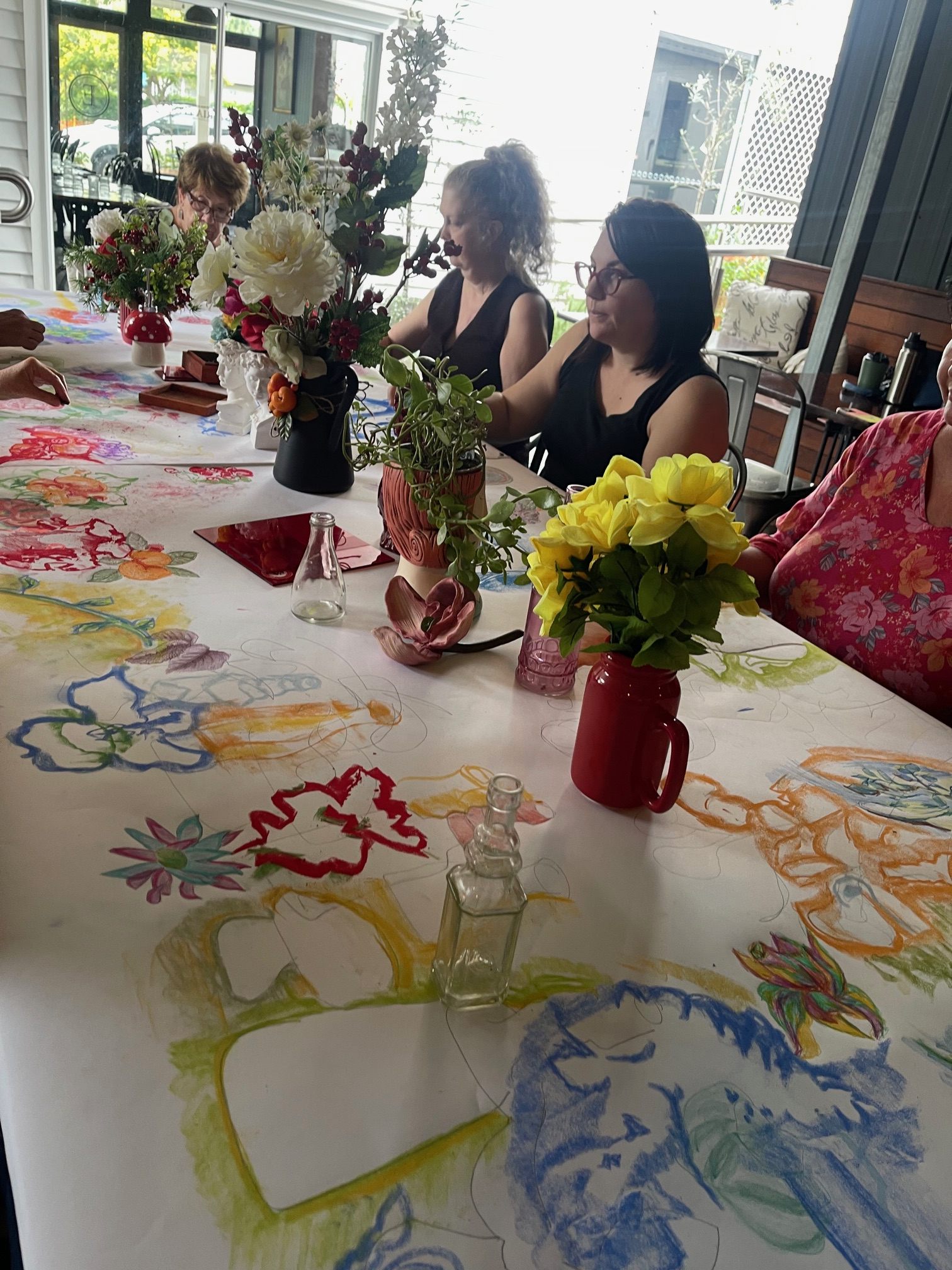 Workshop participants sketching together in the Osteria Epoca space